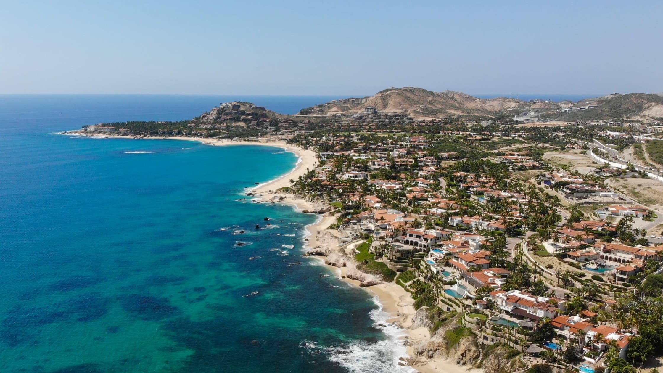 Aerial view of San José del Cabo coastline with turquoise waters and luxury resorts