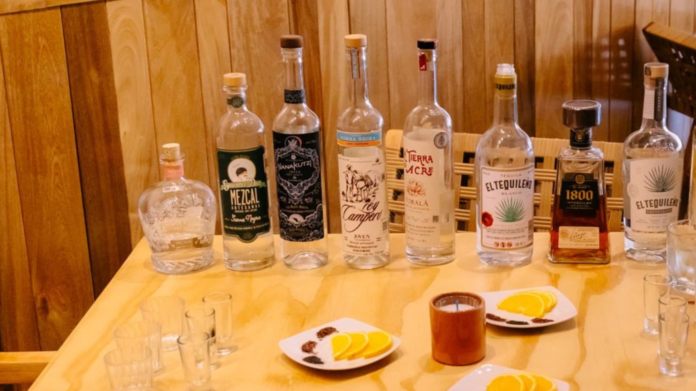 Professional tequila tasting setup with various glasses and premium bottles